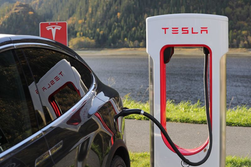 Photograph of a Tesla electric car being charged in a charging station.